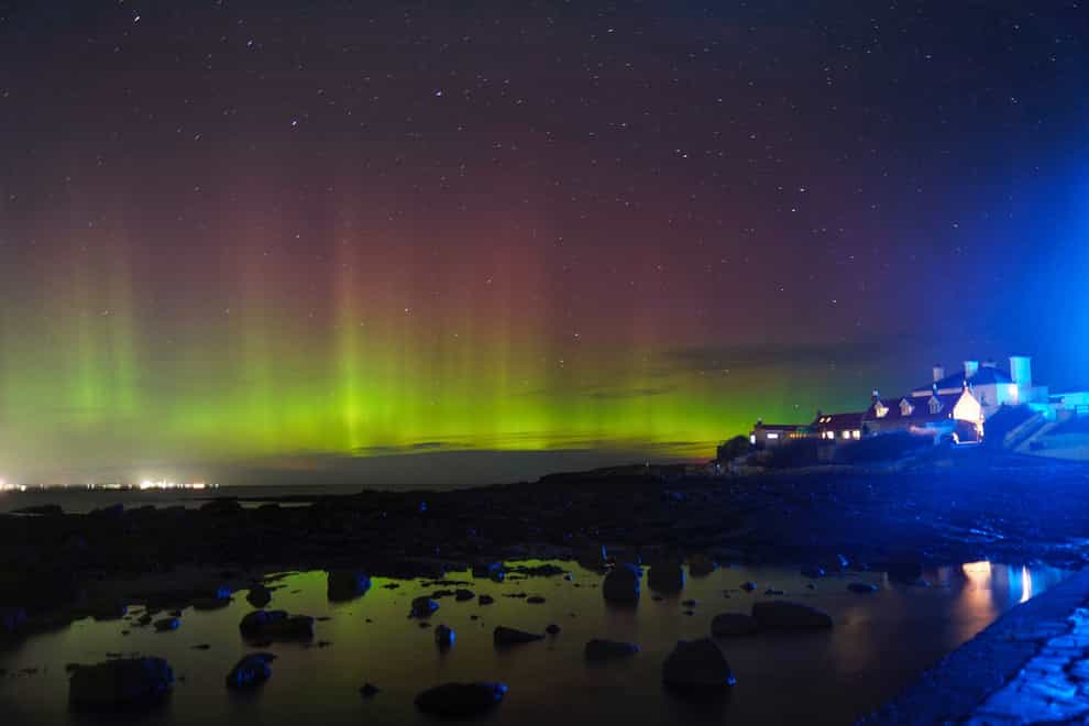 The aurora borealis, better known as the northern lights, over St Mary’s Island, North Tyneside (Owen Humphreys/PA)