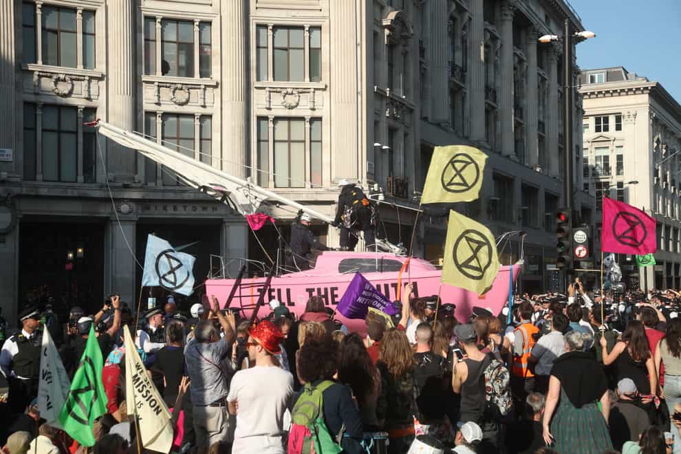 Police take control of Extinction Rebellion’s ‘Tell the Truth’ boat, as protests continue at Oxford Circus in London.