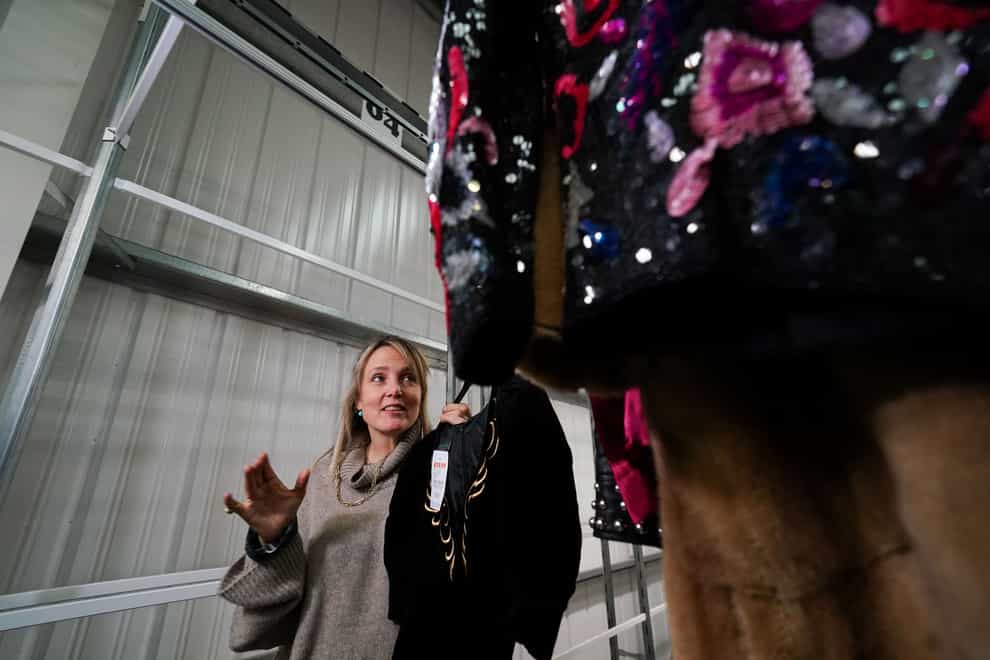 Oxfam fashion stylist Bay Garnett at the Oxfam warehouse in Milton Keynes shows some of the outfits she has put together for London Fashion Week where Oxfam will have a runway show for the first time. A catwalk show with items from Oxfam will feature at London Fashion Week in February. Bay Garnett, who put together the outfits for Oxfam???s show, has said shopping in charity shops is a sustainable way of enjoying fashion, and wearing second-hand clothing has become an act of “rebellion” for young people concerned about climate change. Picture date: Monday December 5, 2022.