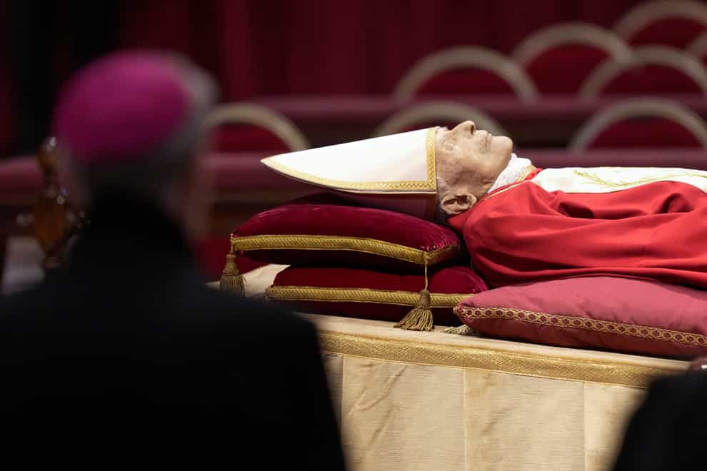 The body of late Pope Emeritus Benedict XVI laid out in state inside St. Peter’s Basilica at The Vatican, Monday, Jan. 2, 2023. Benedict XVI, the German theologian who will be remembered as the first pope in 600 years to resign, has died, the Vatican announced Saturday. He was 95. (AP Photo/Andrew Medichini)