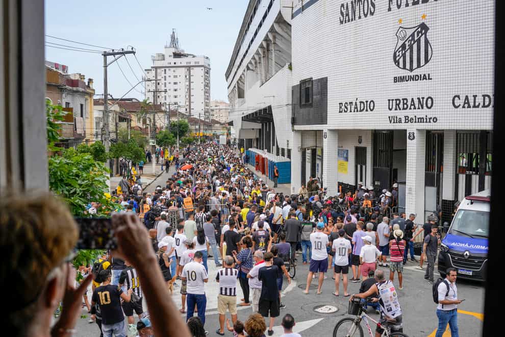 Football fans line up to attend the funeral of the late Brazilian legend Pele at the Vila Belmiro stadium in Santos, Brazil on Monday, January 2, 2023 (Matias Delacroix/AP/PA)