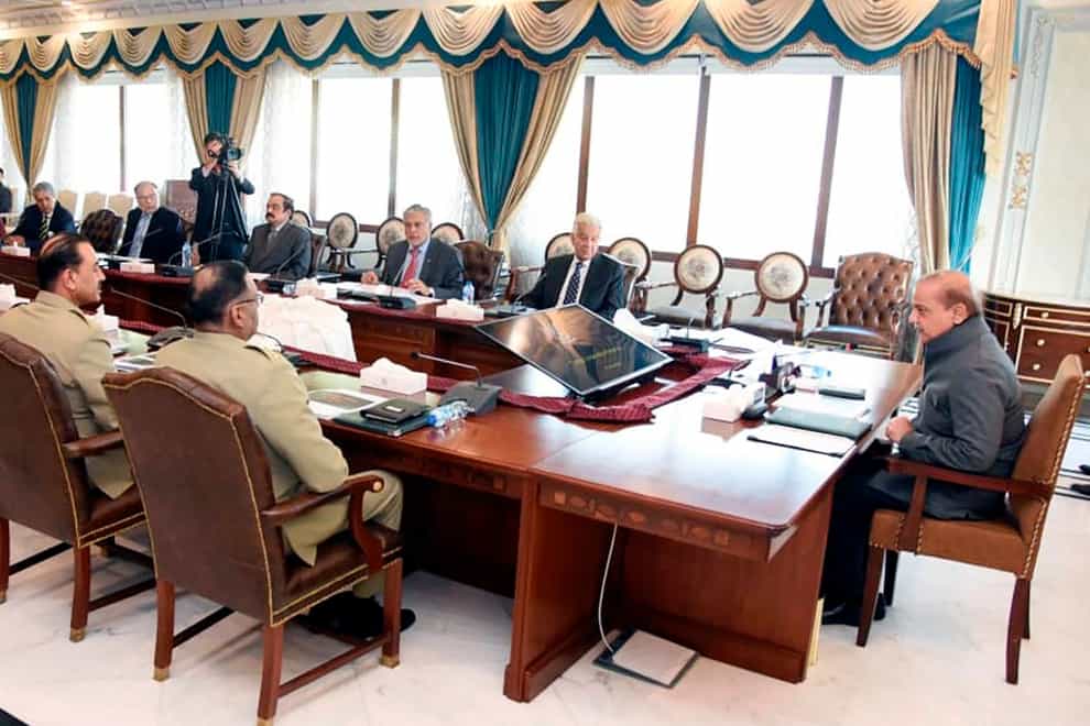 Pakistan’s Prime Minister Shahbaz Sharif, right, chairs a meeting of National Security Committee, in Islamabad, Pakistan (Press Information Department via AP/PA)