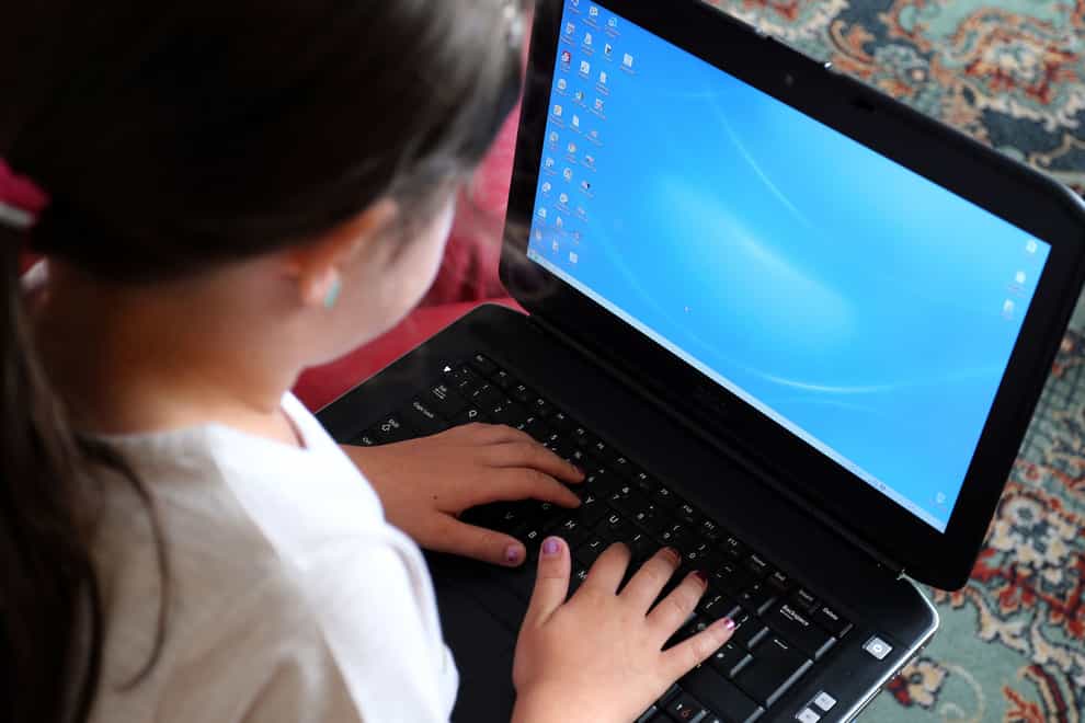 File photo dated 21/08/14 of a child using a laptop (Peter Byrne/PA)