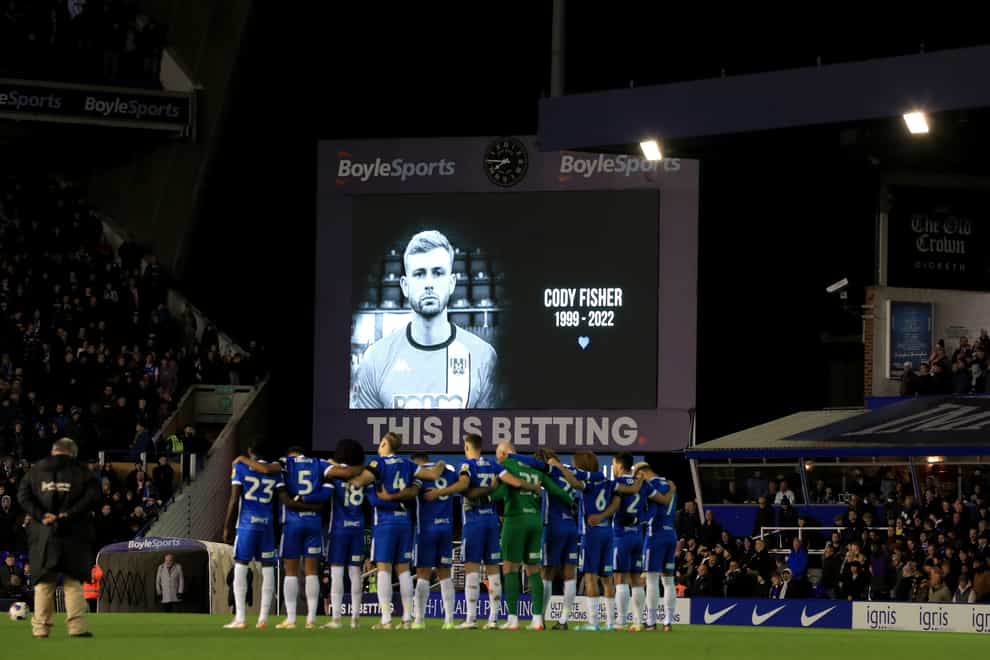 Football players observe a minute’s silence for Cody Fisher (Bradley Collyer/PA)