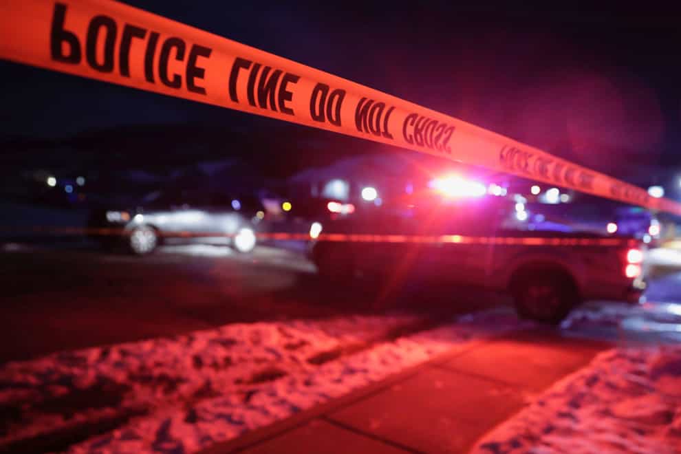 Police tape surrounds the crime scene in Enoch, Utah, where eight members of a family were found dead from gunshot wounds (Ben B. Braun/The Deseret News/AP)