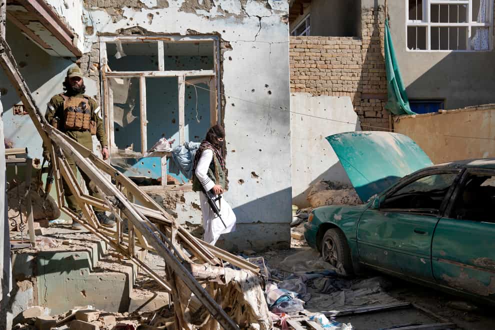 Taliban fighters check a so-called Islamic State group house destroyed in the ongoing conflict between the two in Kabul, Afghanistan, on Thursday January 5 2023 (Ebrahim Noroozi/AP)