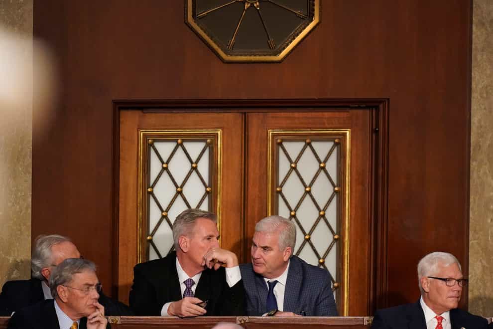 Kevin McCarthy talks to colleagues during a sixth round of voting in the House chamber (Alex Brandon/AP)