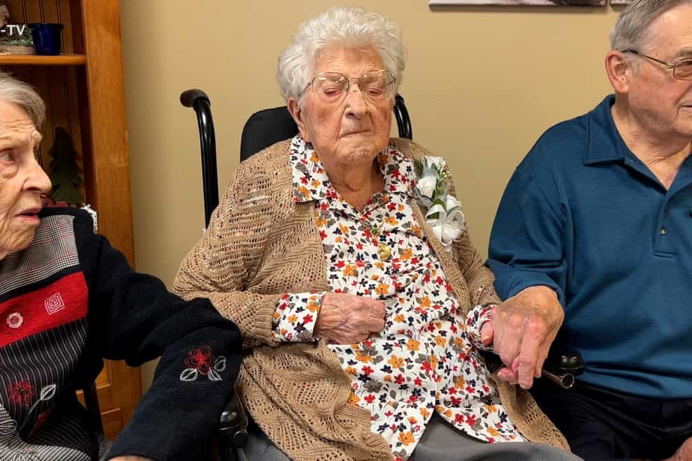 This image made from video, provided by KCCI 8 News in Des Moines, Iowa, shows Bessie Laurena Hendricks, center, celebrating her 115th birthday in November 2022. Hendricks, an Iowa woman who was believed to be the oldest living person in the U.S., died Tuesday, Jan. 3, 2023, at the age of 115. (KCCI 8 News via AP)
