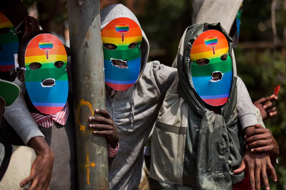 Kenyan members and supporters of the LGTB community wear masks to preserve their anonymity as they stage a protest in Nairobi, Kenya, in 2014 (Ben Curtis/AP)