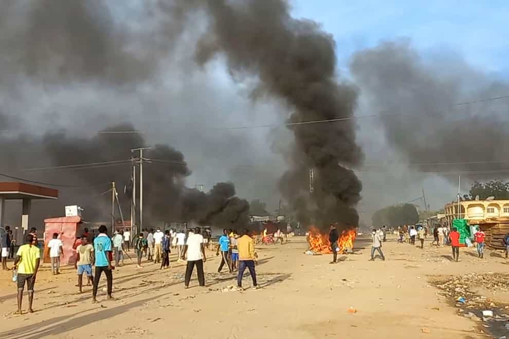 Anti-government demonstrators set a barricade on fire during clashes in N’Djamena (PA)