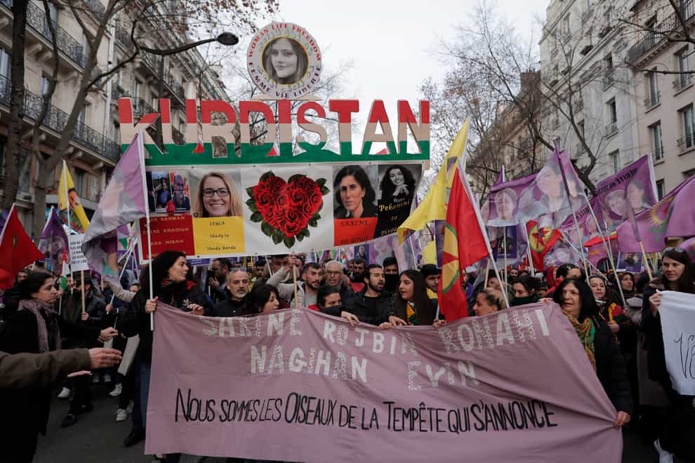 Kurdish activists march during a protest in Paris (AP)