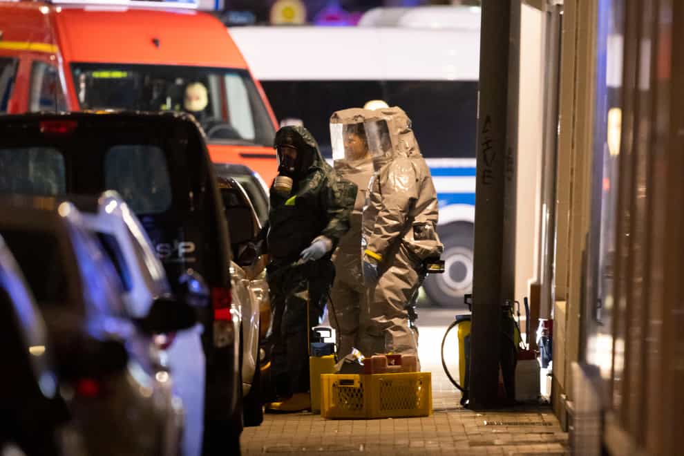 Investigators in protectives suits at the scene in Castrop-Rauxel (Christoph Reichwein/dpa via AP)