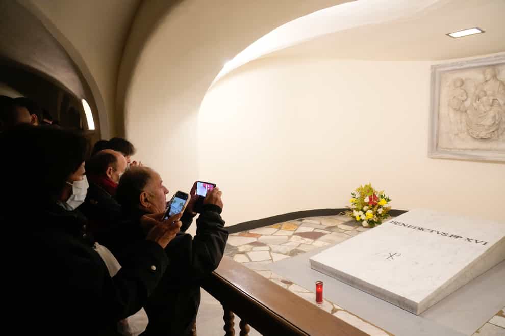 People visit the tomb of late Pope Emeritus Benedict XVI (Gregorio Borgia/AP)