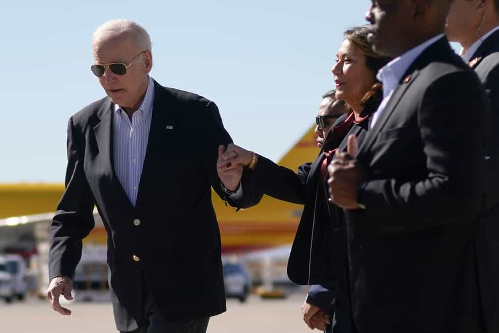 Rep Veronica Escobar holds the hand of President Joe Biden as they arrive at El Paso International Airport in El Paso, Texas (Andrew Harnik/AP/PA)