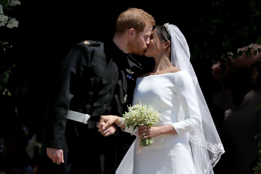 Harry and Meghan kiss outside St George’s Chapel in Windsor Castle on their wedding day (PA)