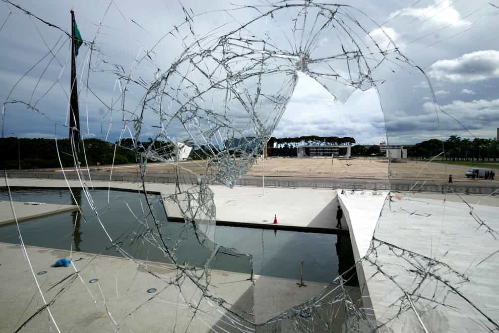 The Supreme Court is seen on the other side of broken glass (Eraldo Peres/AP)