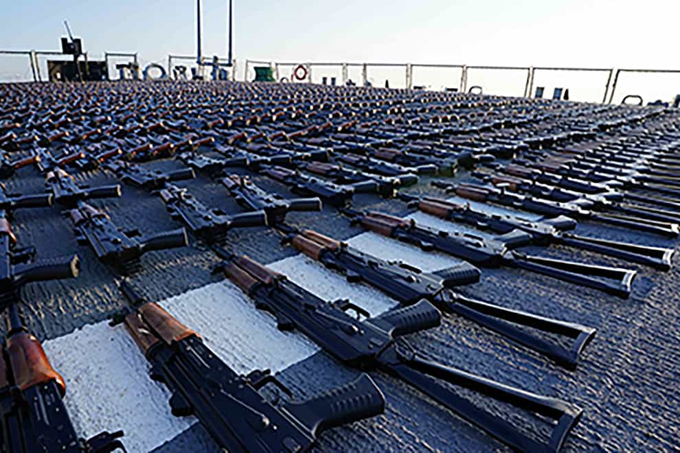 Hundreds of AK-47 assault rifles sit on the flight deck of the destroyer USS The Sullivans (US Navy photo via AP)