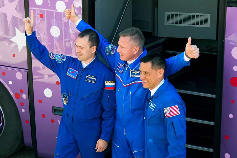 The three space station crew members were supposed to return in March in the same Soyuz capsule that took them up last September (Dmitri Lovetsky/AP)