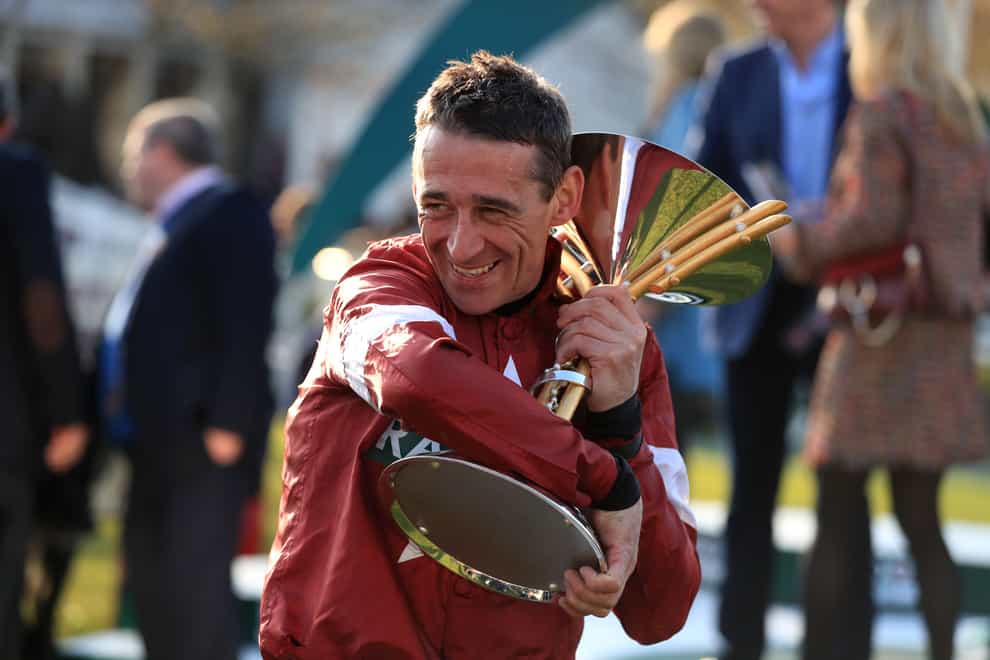 Jockey Davy Russell celebrates with the trophy after winning the Randox Health Grand National Handicap Chase with Tiger Roll during Grand National Day of the 2019 Randox Health Grand National Festival at Aintree Racecourse.
