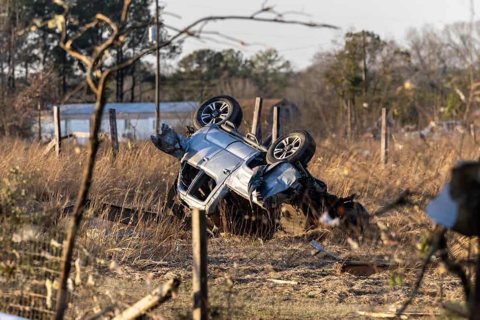 An SUV is overturned near 1349 County Road 43 in the aftermath from severe weather in Prattville, Alabama (Vasha Hunt/AP)