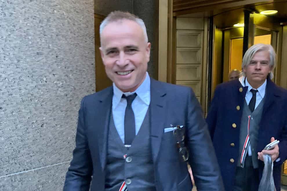 Fashion designer Thom Browne leaves Manhattan federal court in New York after a jury decided he did not infringe the trademark of sportswear giant Adidas (Larry Neumeister/AP)