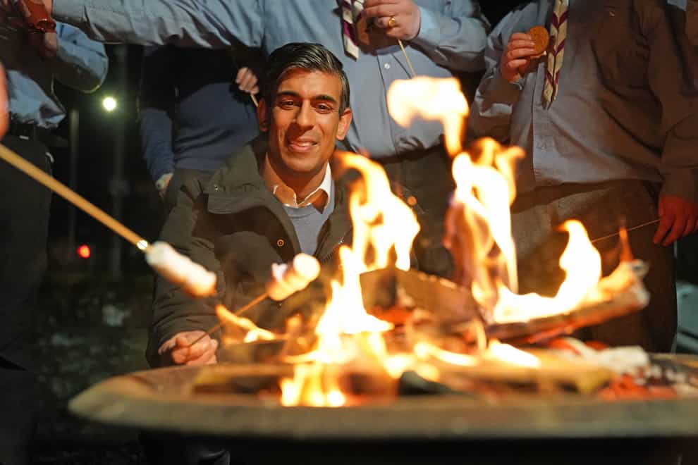 Rishi Sunak toasts marshmallows during a visit to the Sea Scouts community group in Muirtown near Inverness (Andrew Milligan/PA)