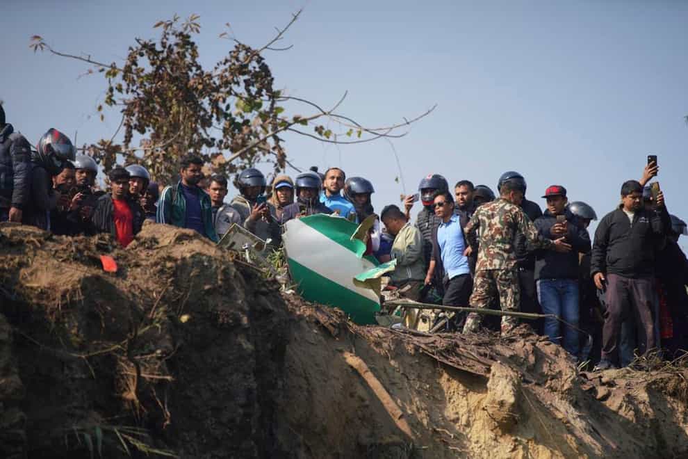 Sixty people have been confirmed dead after a regional passenger plane with 72 on board crashed into a gorge while landing at a newly-opened airport in Nepal (Yunish Gurung/AP)