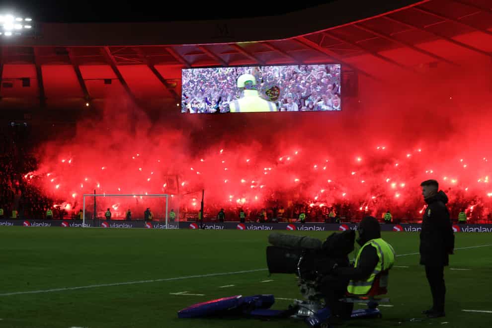 Celtic fans set off flares in the stands before the Viaplay Cup semi-final (PA)