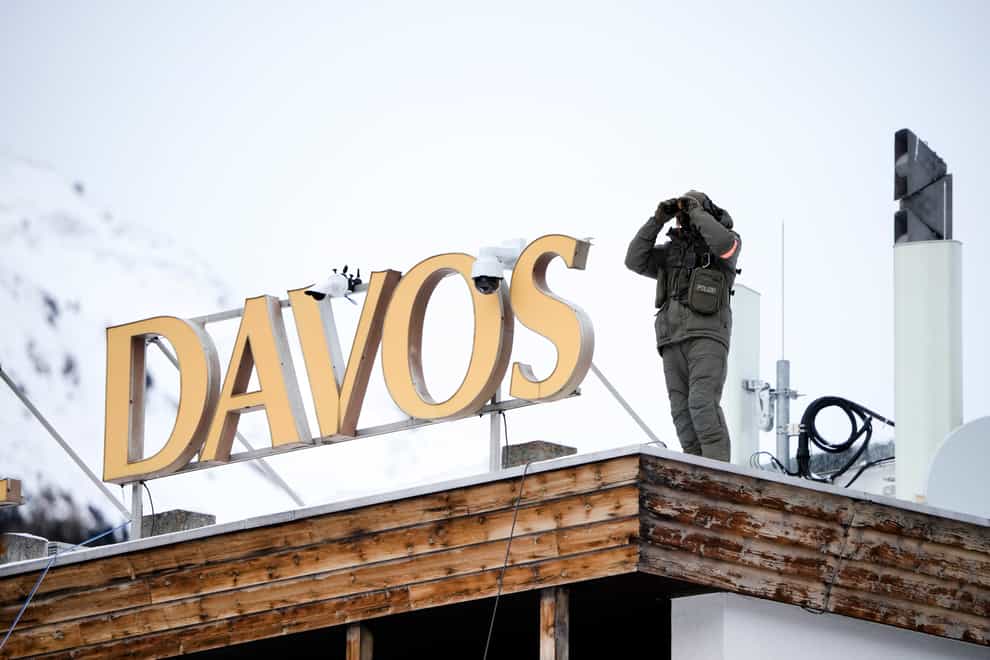 A police officer stands on the roof of a hotel in Davos (Markus Schreiber/PA)