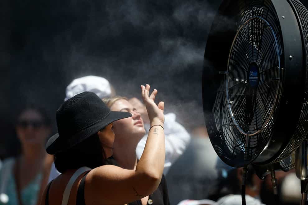 Fans try to cool down at the Australian Open (Asanka Brendon Ratnayake/AP)