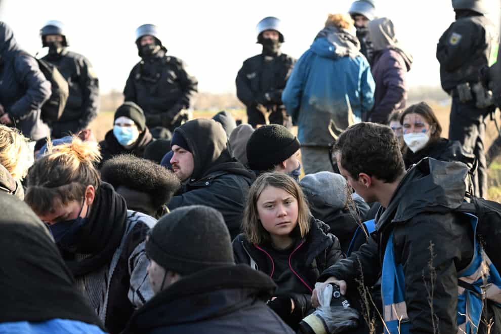 Police officers encircled a group of activists and coal mine opponents including Greta Thunberg (Federico Gambarini/dpa via AP)