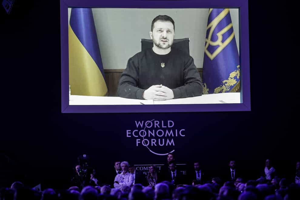 President Volodymyr Zelensky talks from a video screen to participants at the World Economic Forum in Davos, Switzerland (Markus Schreiber/AP/PA)