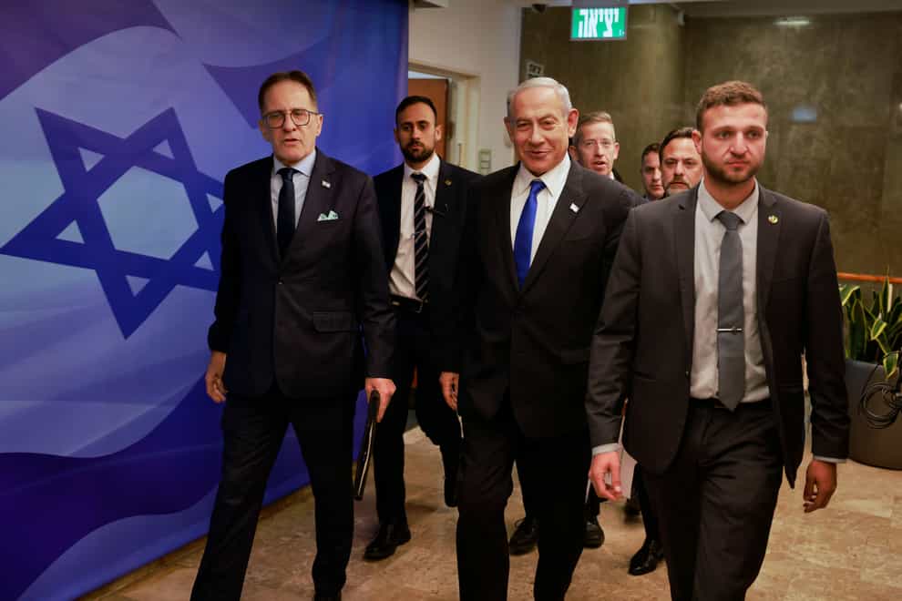 Israeli Prime Minister Benjamin Netanyahu, centre, arrives for a weekly cabinet meeting at the Prime Minister’s office in Jerusalem (Menahem Kahana/Pool Photo via AP/PA)
