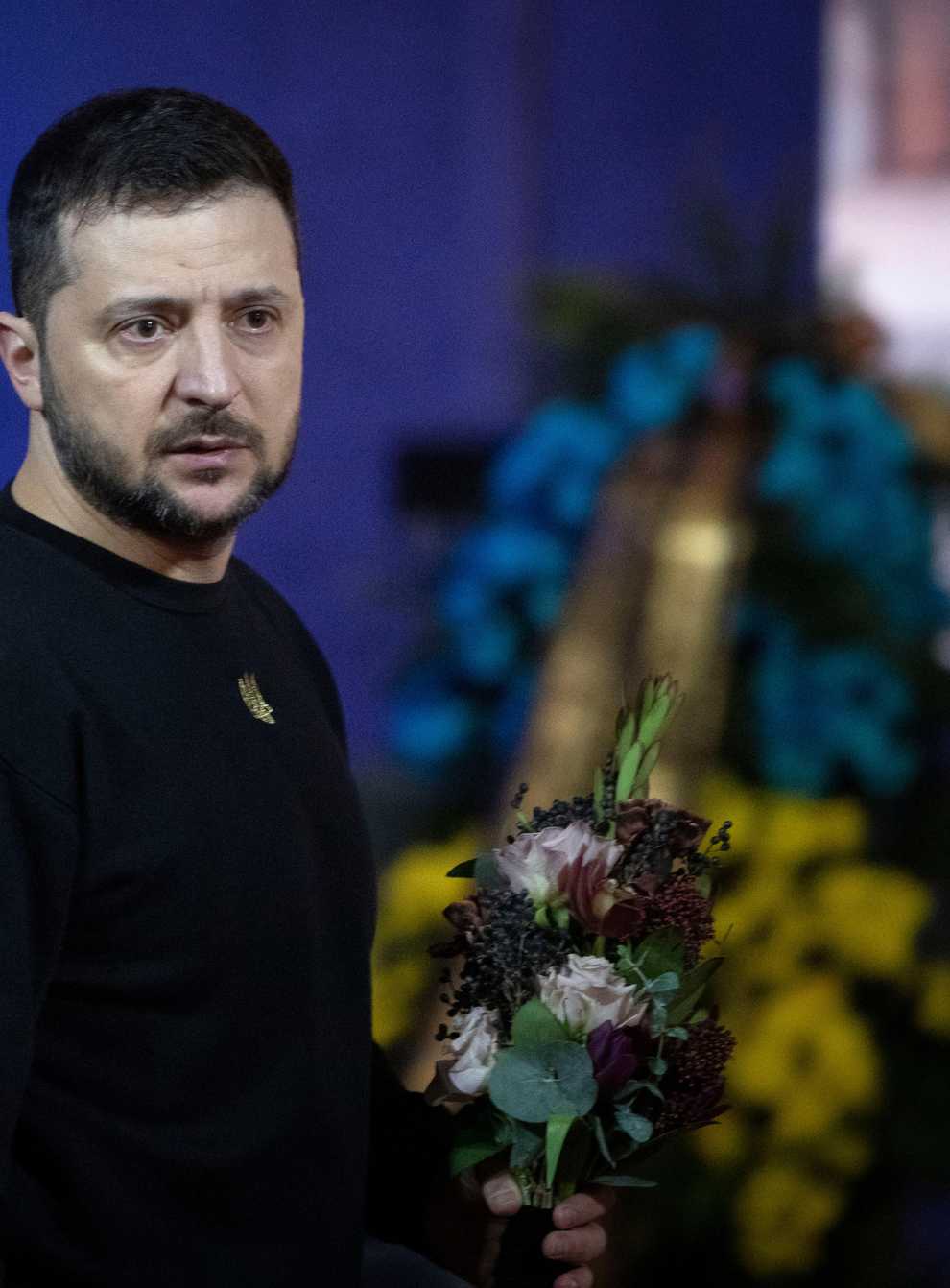 Ukrainian President Volodymyr Zelenskyy pays his respects to victims of a deadly helicopter crash during a farewell ceremony in Kyiv, Ukraine, Saturday, Jan. 21, 2023. Interior Minister Denys Monastyrsky, his Deputy Yevhen Yenin, State Secretary Yurii Lubkovych, national police official and the three crew members were killed in a helicopter crash on Wednesday in Kyiv suburbs of Brovary. (AP Photo/Efrem Lukatsky)