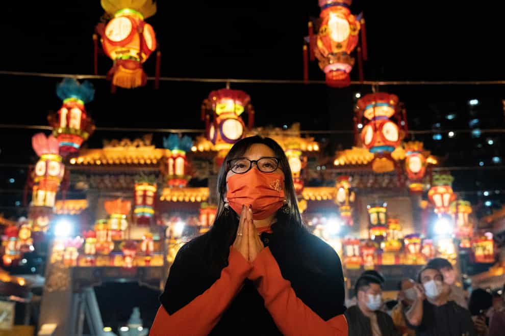 A woman offers prayer at the Wong Tai Sin Temple, Saturday, Jan. 21, 2023, in Hong Kong, to celebrate the Lunar New Year (Bertha Wang/AP/PA)