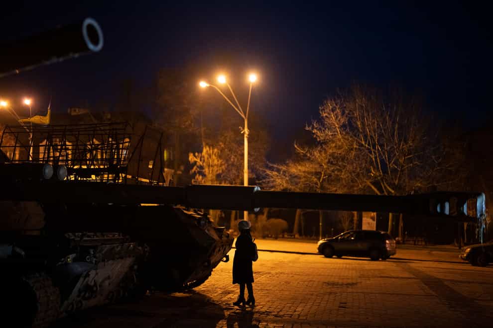 A woman stands in front of a display of destroyed Russian tanks and armoured vehicles in Kyiv (Daniel Cole/AP)