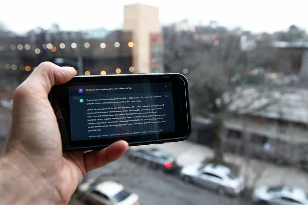 A ChatGPT prompt is shown on a device near a public school in Brooklyn (AP)