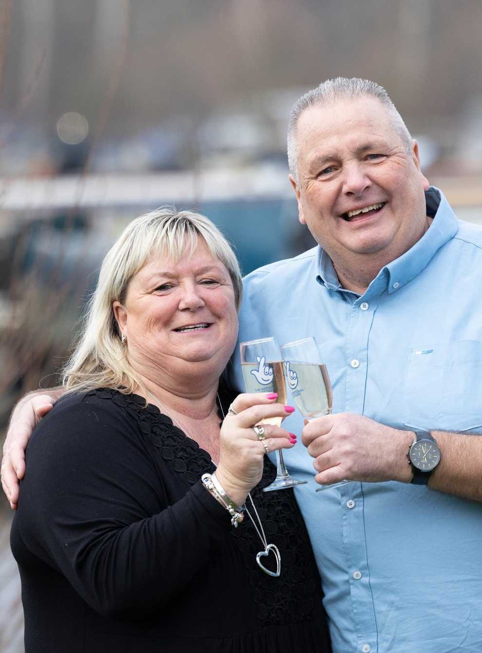 Jeff Etherington and Kim Read toast their £500,000 windfall (National Lottery/PA)