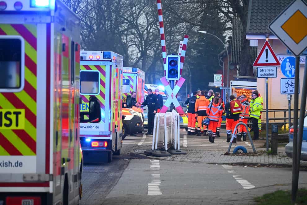Police and rescue services at a level crossing near Brokstedt station in Brockstedt, German (Jonas Walzberg/dpa via AP)