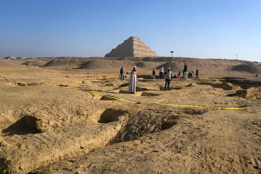 Egyptian antiquities workers dig at the site of the Step Pyramid of Djoser in Saqqara (Amr Nabil/AP)
