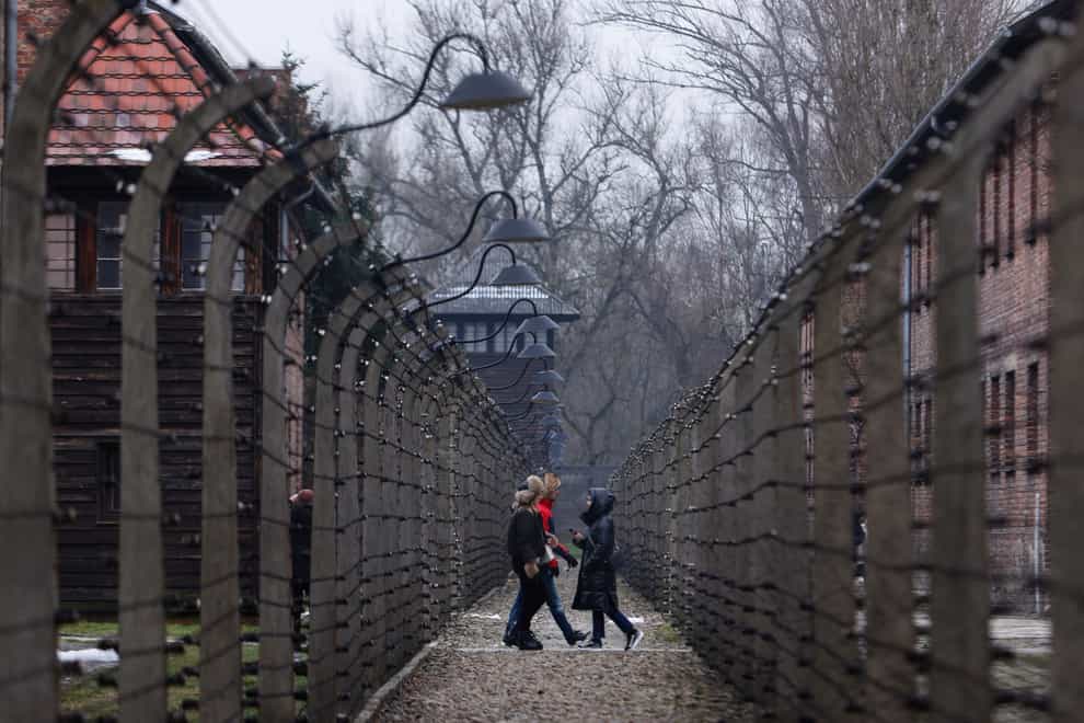 People visit the former Nazi German concentration and extermination camp Auschwitz-Birkenau in Oswiecim, Poland (Michal Dyjuk/AP)