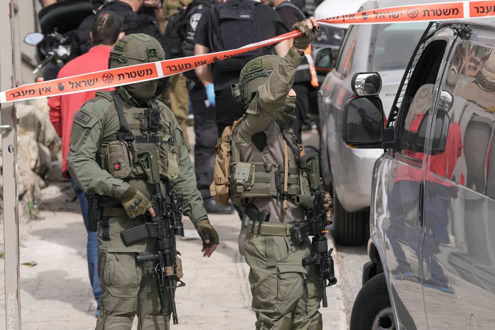 Israeli policemen secure a shooting attack site in east Jerusalem (AP)