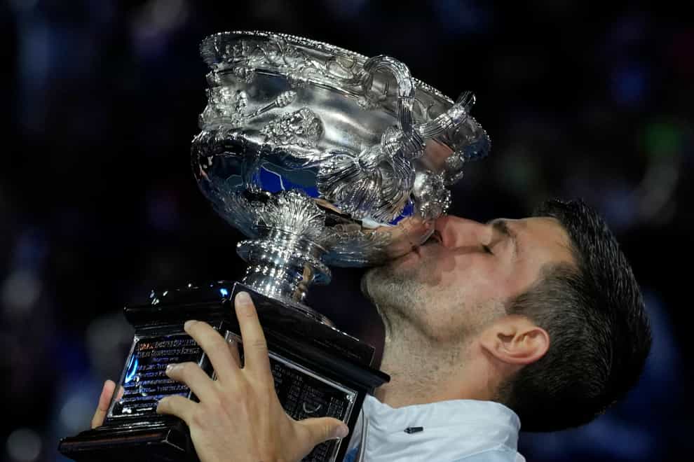 Novak Djokovic kisses the Norman Brookes Challenge Cup (Aaron Favila/AP)