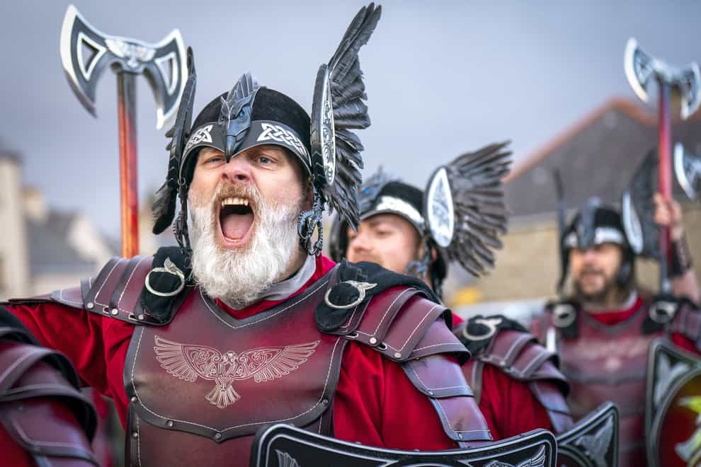 Members of the Jarl squad give a war cry as they march through Lerwick (Jane Barlow/PA)