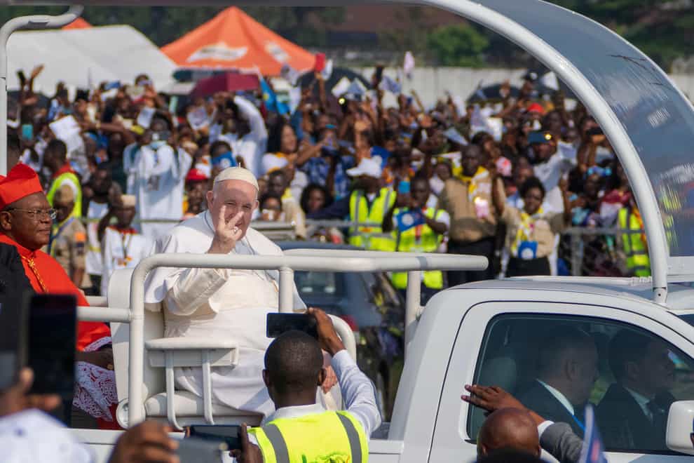 Pope Francis arrives at Ndolo airport (AP)