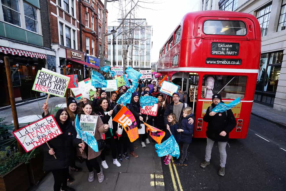 Striking teachers from the National Education Union disembark from a bus in Soho, central London, as they head to a protest march (PA)