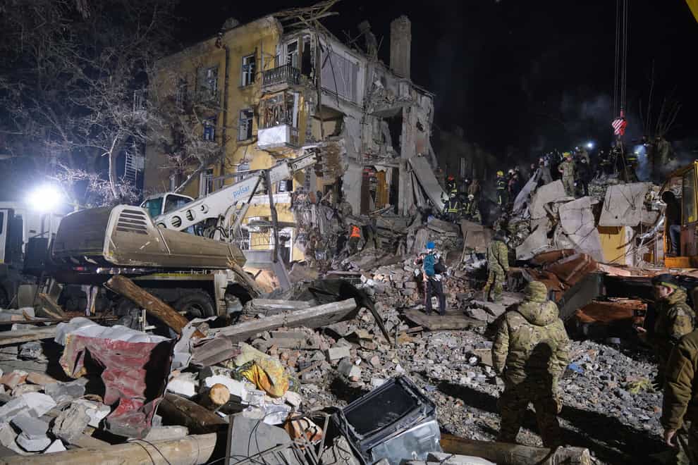 Emergency workers clear the rubble after a Russian rocket hit an apartment building in Kramatorsk, Ukraine, on Thursday February 2 2023 (Yevgen Honcharenko/AP)