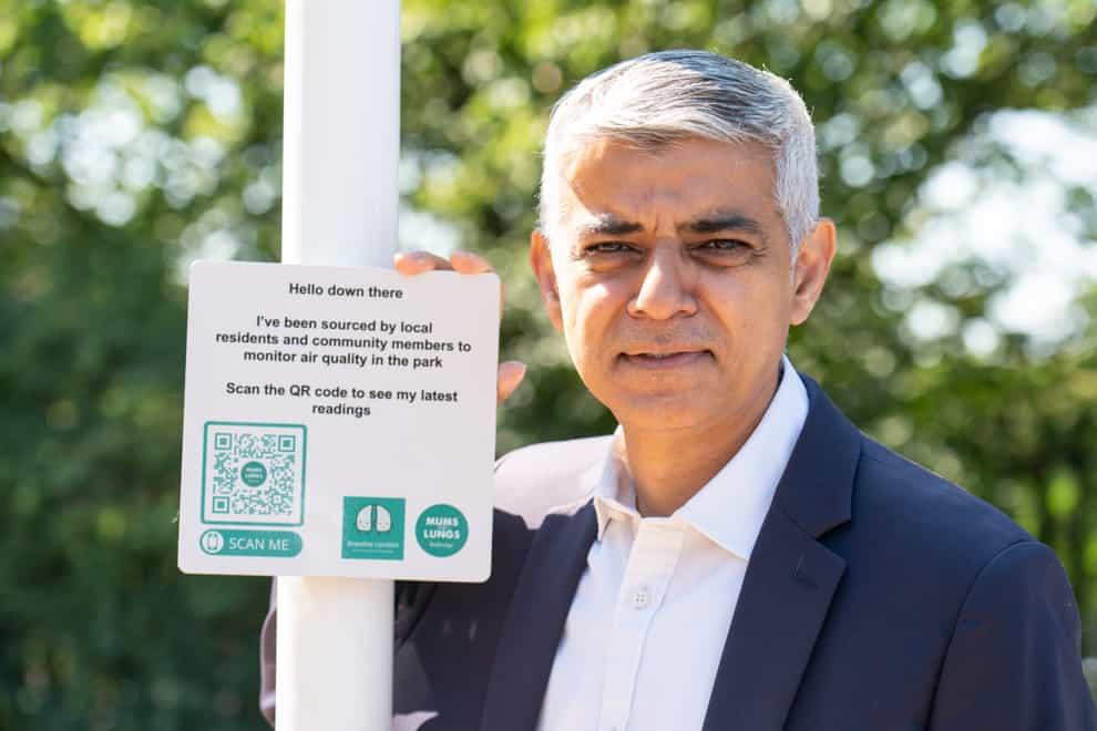 Mayor of London Sadiq Khan with an air quality monitoring station sign (Dominic Lipinski/PA)