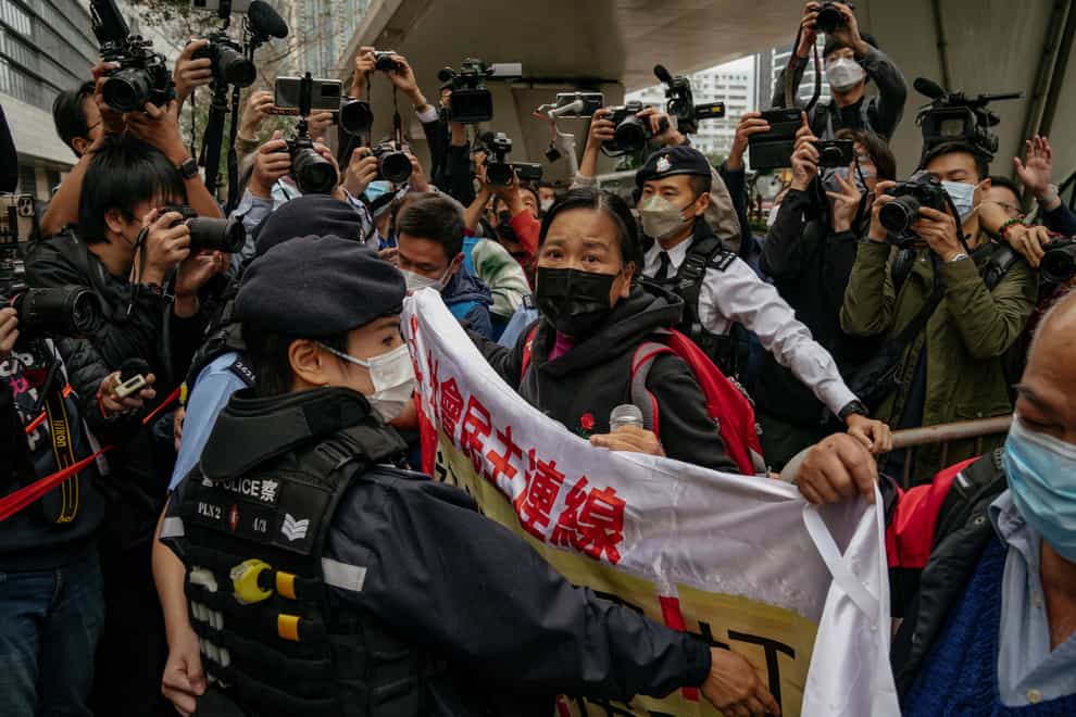 Members of the League of Social Democrats scuffle with police outside the West Kowloon Magistrates’ Courts (AP)