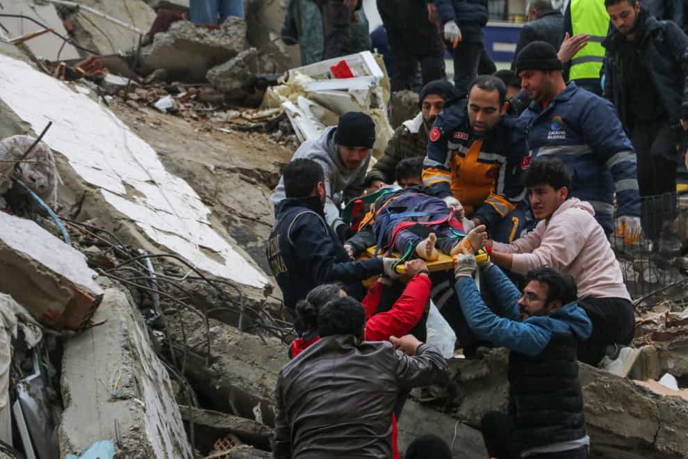 Rescue efforts at a collapsed building in Adana, Turkey (IHA via AP)
